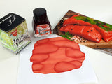 Bottle of Van Dieman's Tassie Salmon with swatch and picture of salmon